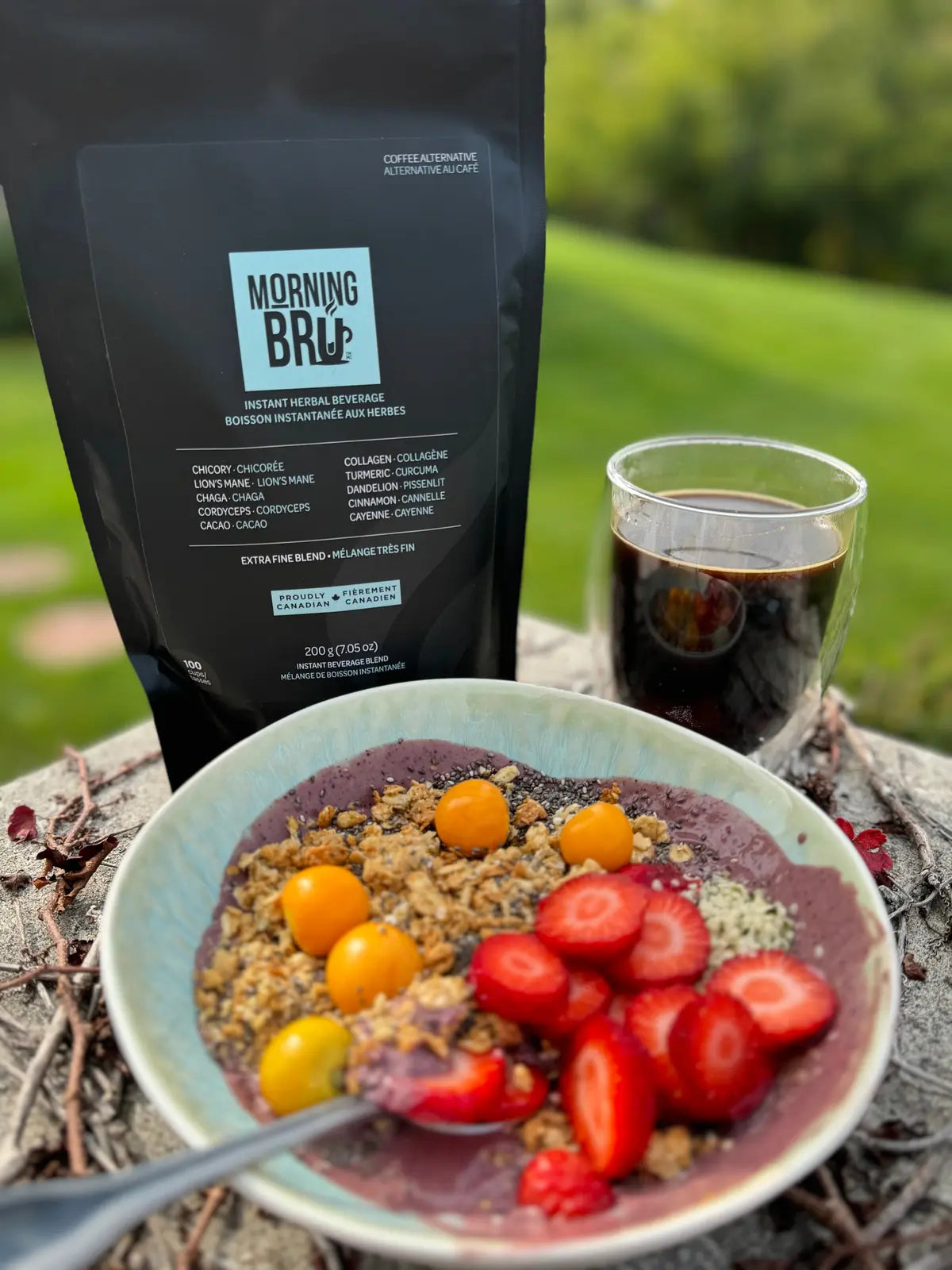 Breakfast scene with a bowl of fruit and granola, a cup of coffee, and a package labeled 'Morning Brew' on a natural background.